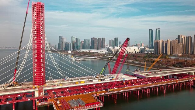 Aerial view of cranes and construction equipment are working to dismantle an old cable stayed bridge.