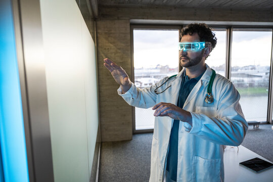 Doctor in office using augmented reality to interact with data