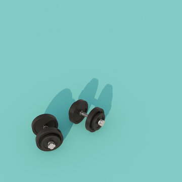 Two black dumbbells on turquoise background with copy space