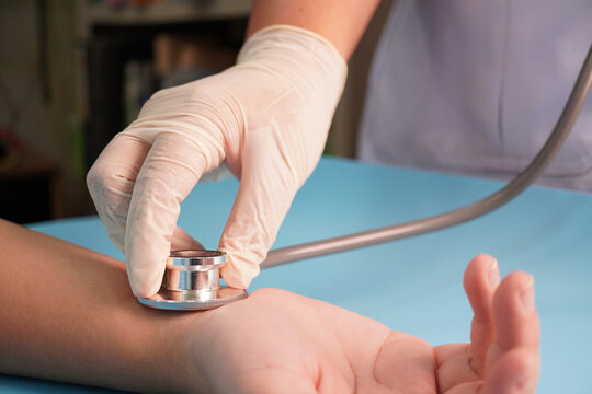 Healthcare Worker Checking Wrist Pulse with Stethoscope | Clinical Examination Education Concept