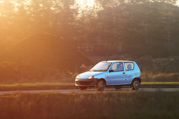 Obraz premium Classic white hatchback on countryside