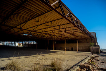 Fototapeta premium Abandoned Industrial Warehouse Interior with Decay
