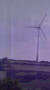 Vertical video: Wind turning turbine blades slowly on hillside, harnessing energy under purple tint