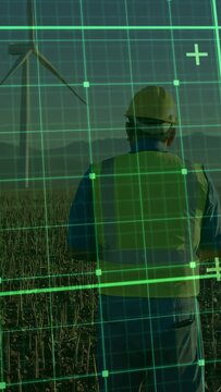Vertical video: Hardhat tech walking to turbine, AR grid engaging on approach guiding energy check