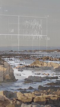Vertical video: Coast rocks holding view pan sparking faint grid bars rising wave tilting for tides