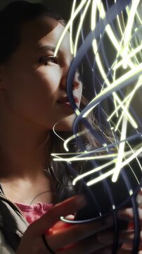 Vertical video: Woman lifting gaze in car sparking IT light trails rising around phone seeing trees