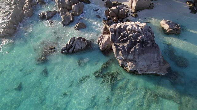 Bird eye top down drone of beautiful rocks near the shoreline of Anse Patates, La Digue, Seychelles 023, 30fps