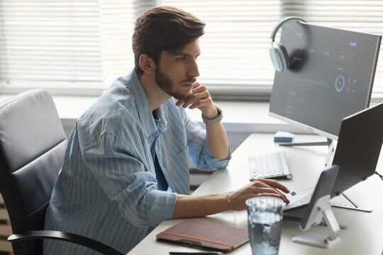 Programmer working on computer at office desk