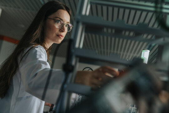 Scientist working with machine in laboratory setting