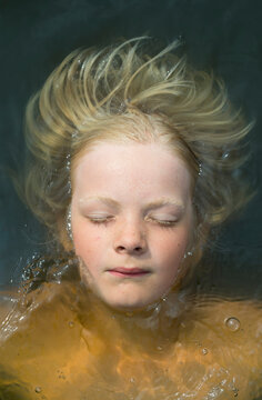 Person floating in water with closed eyes in the Netherlands