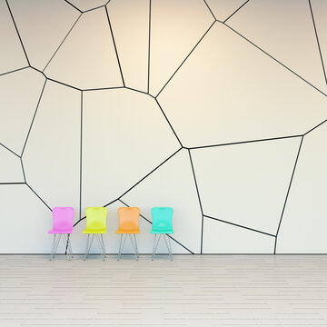 Four colorful chairs in a modern waiting area with geometric wall