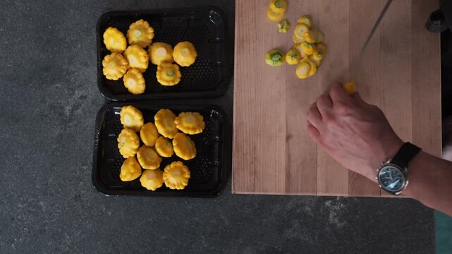Pattypan squash is cut and prepared for a meal (slow motion, 4K)