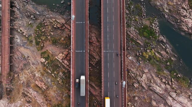 Vehicles moving on Tungabhadra Bridge, NH67 with NH50 and Ballari - Hubballi Road, Munirabad Project Area, Karnataka, india. day time, top down shot, stable shot, drone shot, 4k.
