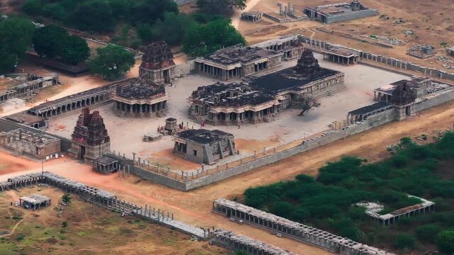 Temple ruins of Shri Achyutaraya Swamy Temple with trees at vijayanagara, hampi, karnataka, india. day time, stable shot, drone shot, 4k.