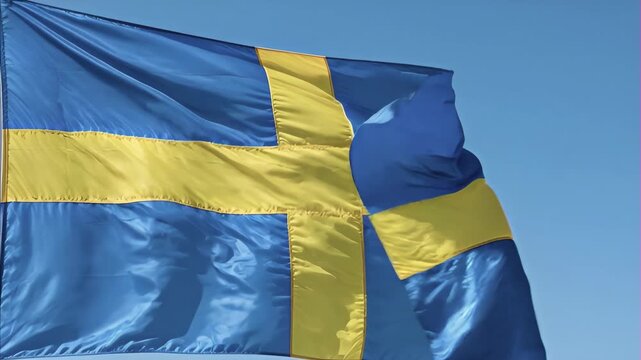 Swedish flag waving against clear blue sky, vibrant colors of national symbol flowing in wind, representation of patriotism and national pride, Sweden's National Day June 6