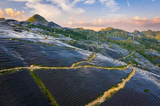 Aerial view of large scale solar power plant on green mountain slopes for renewable energy production in Guizhou, China