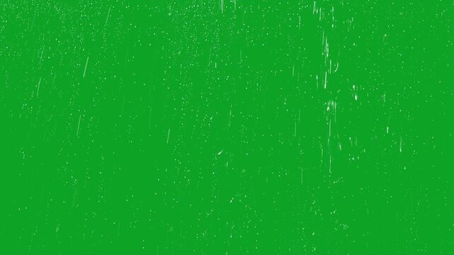 Realistic water droplets and rain streaks falling on glass green screen overlay