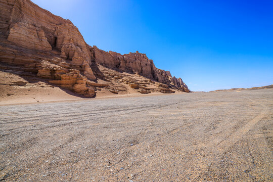 Scenic yardang landforms in the Gobi desert under a clear blue sky in Xinjiang, China