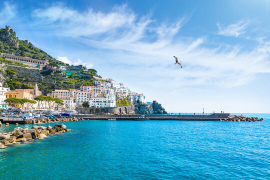 Picturesque Amalfi Coast Italy with Italian architecture cascading down cliffs toward turquoise waters of Mediterranean sea. Welcome to Amalfi concept photo