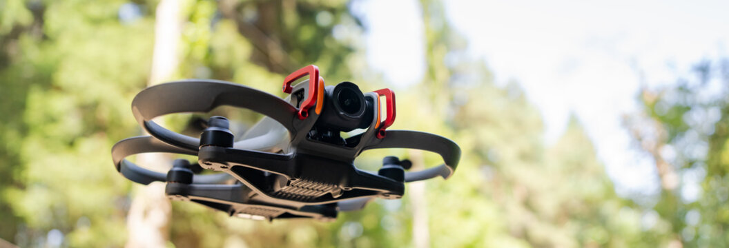 Drone flying above a dense forest, capturing aerial perspectives, exploring natural landscapes, and demonstrating modern technology in outdoor adventure and wildlife observation.