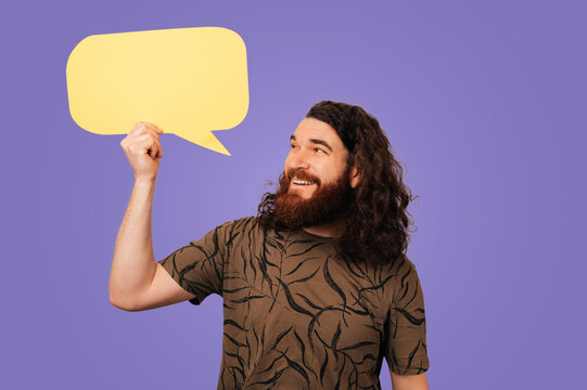 Caucasian Man Holding Yellow Speech Bubble, Smiling Communicator In Patterned Shirt Presenting Message Prop