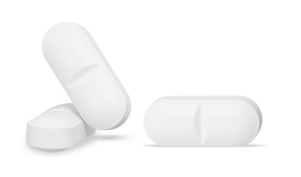 Three white oblong pills with score marks isolated on transparent background