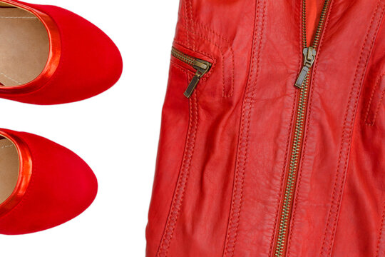 Red shoes and a leather jacket are placed on a white background with no other items in view showcasing fashion choices