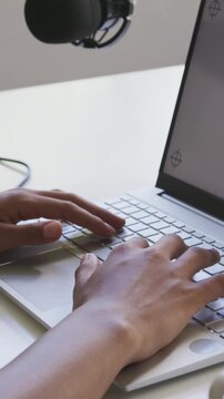 Hands landing on home row and typing on laptop, wrists shifting, microphone recording