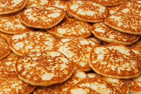 Background and texture of a mountain of pancakes. Side view. Fresh homemade pancakes.