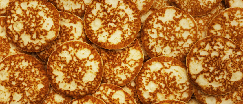 Background and texture of a mountain of pancakes. View from above. Fresh homemade pancakes. Panorama.