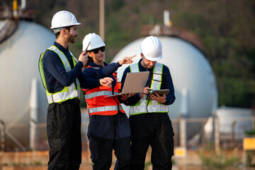 Fototapeta premium Engineering team at an oil refinery discussing operations