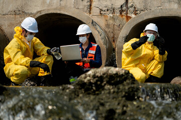 Fototapeta premium Group of scientists in protective suits are collecting water samples