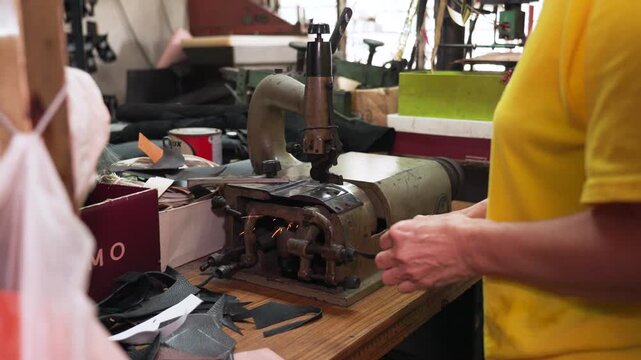 Close-up of shoe sskiving machine, showing industrial tools, craftsmanship process, and traditional footwear production environment. UHD.