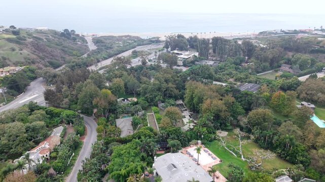 Wealthy Properties In The Coastal Neighborhood Of Point Dume And Zuma Beach On A Foggy Day In Malibu, California. Aerial Flyover.