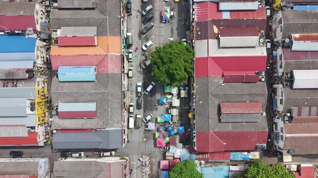 Top-down aerial view of Cheras district market street in Kuala Lumpur, Malaysia. Dense urban layout with colorful rooftops, street activity, and a local commercial area.