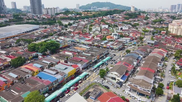 Fast push in aerial shot of Cheras district market street in Kuala Lumpur, Malaysia. Dense neighborhood with shops and traffic showcasing local commerce, urban life, and city structure.