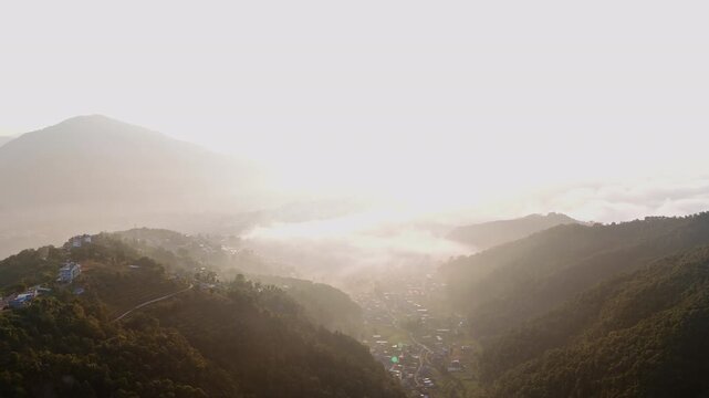 AERIAL: Atmospheric sunrise over Himalayan foothills and valleys of Pokhara, Nepal