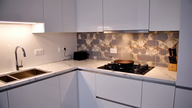 Modern white kitchen with gray and brown patterned backsplash
