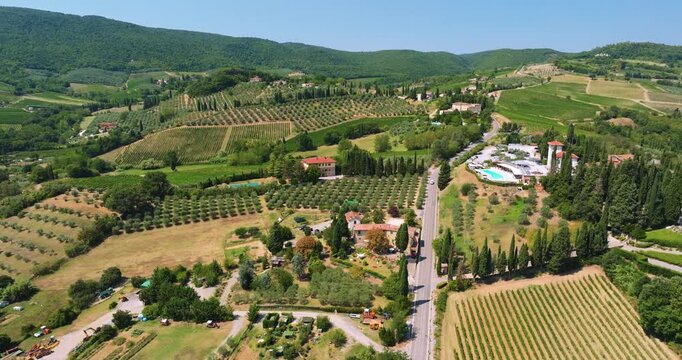 Skyline drone view Italy agricultural land. Vineyards luxury villas green landscape background sunny weather. Italian travel landmark scenic rural landscape exploration destination high angle.
