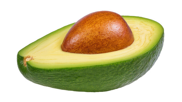 Halved ripe avocado with pit and green skin
