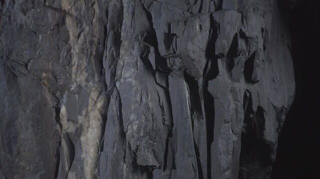 Gray natural rock wall showing rough stone texture