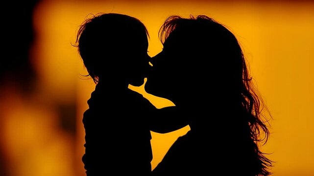 Silhouette of Mother and Child: A tender silhouette captures a loving moment between a mother and her child. bathed in soft light.