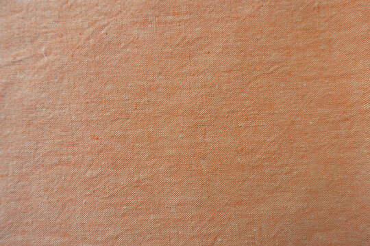 Texture of pale apricot orange durable plain-woven cotton fabric