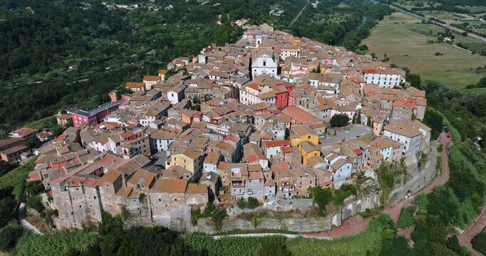 Orte Italy aerial view urban history. Ancient stone architecture hilltop town lush green trees summer. Summer vacation concept Italy tourism destination high angle drone shot exploration heritage.