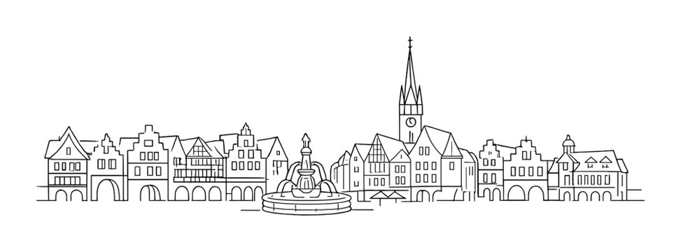 Historic town buildings surrounding a central fountain in plaza