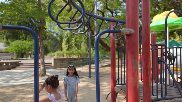 Young Thai Girl Playing on Monkey Bars at Lumpini Park Playground