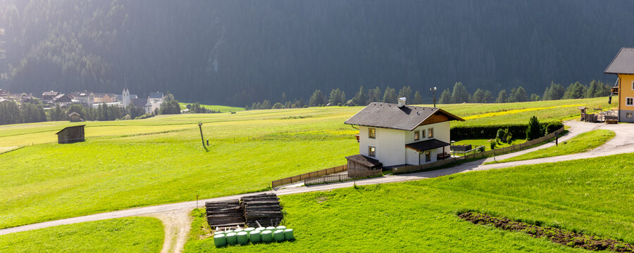 Scenic aerial alpine view austrian mountain village Kals am Grossglockner valley green rural farmland meadow horse pasture background. Austria Alp osttirol National park nature. Summer hiking tourism