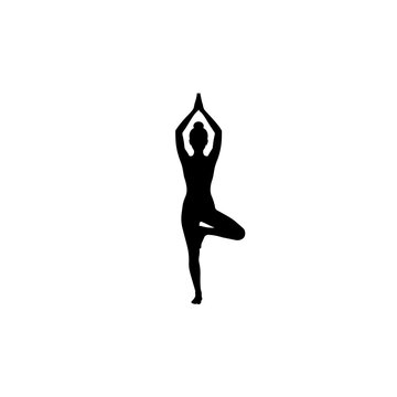 Silhouette of a person performing a one-legged yoga tree pose