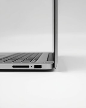 Close-up view of a modern laptop's side port area with usb-c and hdmi ports visible isolated on white background