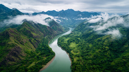 Naklejka premium aerial river bend through lush mountains, vertical perspective of winding river in green mountain valley, ultra distant aerial view of river meander and forested peaks